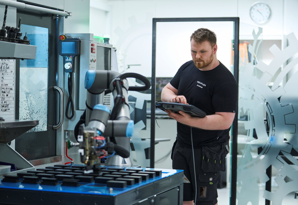 Industrial technician with one of our cobots.