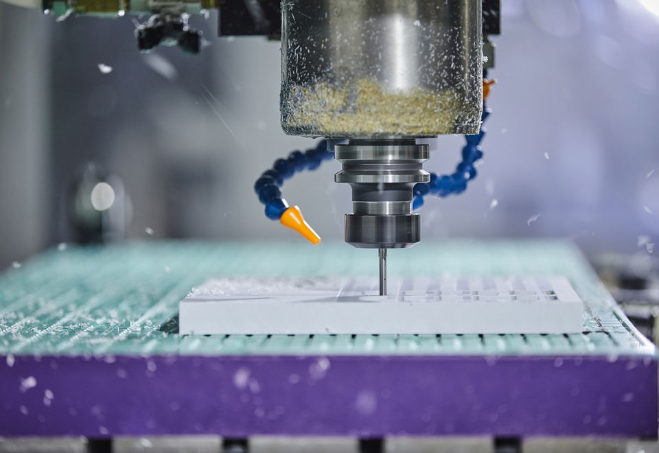 CNC milling mill a part in white plastic with many holes